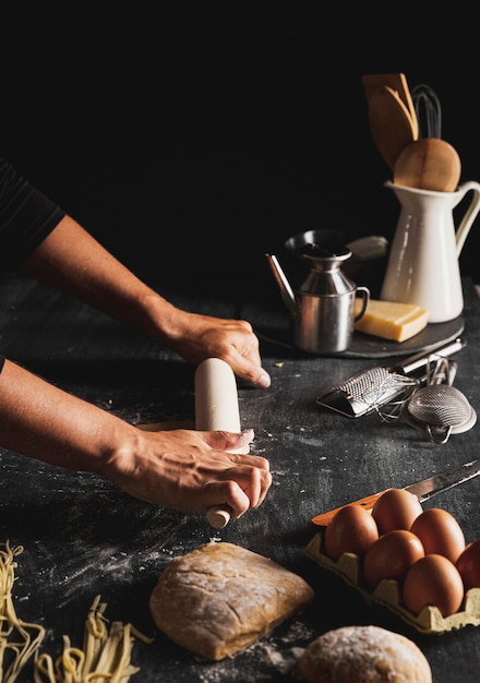 Free photo close-up person holding rolling pin