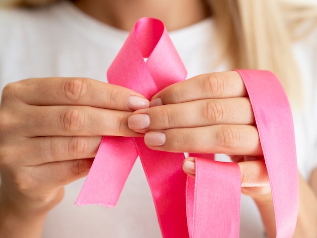 Free photo close-up person holding up awareness ribbon