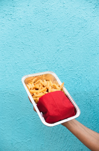 Free photo close-up person holding up junk food