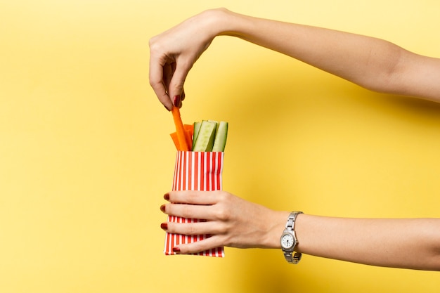 Free photo close-up person holding vegetables