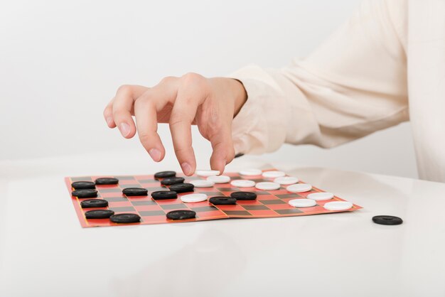 Close-up person playing checkers