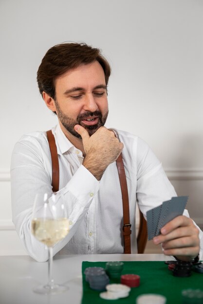 Close up on person playing poker with friends