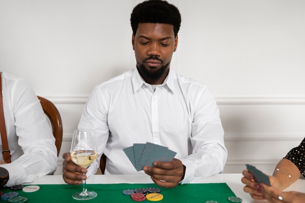 Close up on person playing poker with friends