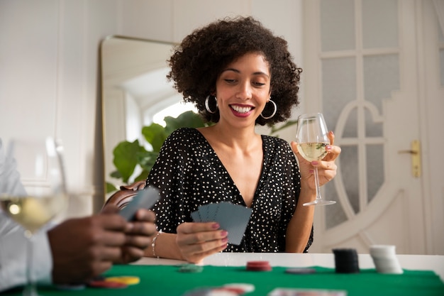 Close up on person playing poker with friends