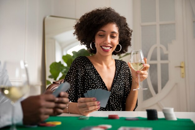 Close up on person playing poker with friends