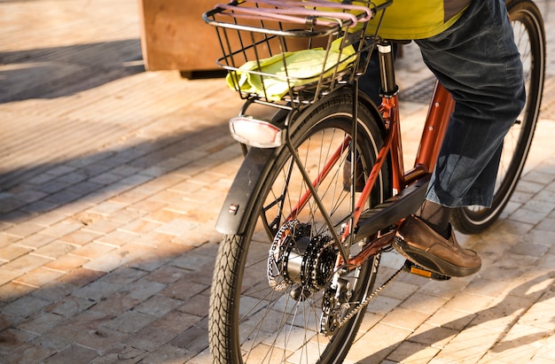 Close-up of a person riding the bicycle on street