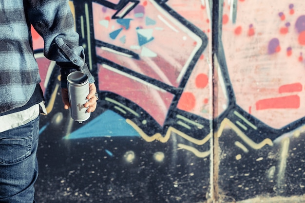 Close-up of person's hand holding aerosol bottle