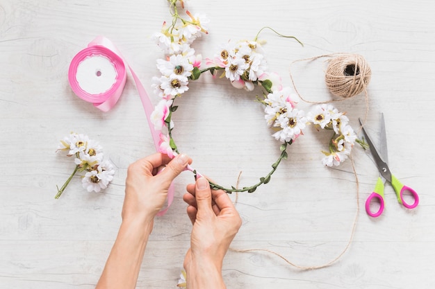 Close-up of person's hand making handmade headbands