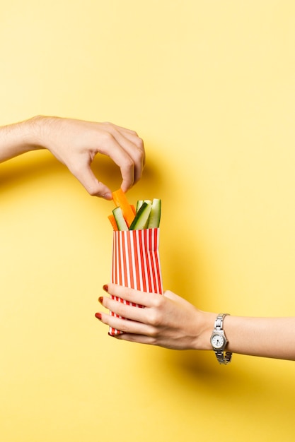 Close-up person sharing vegetables