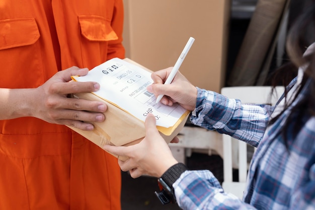 Free photo close up on person signing for parcel delivery