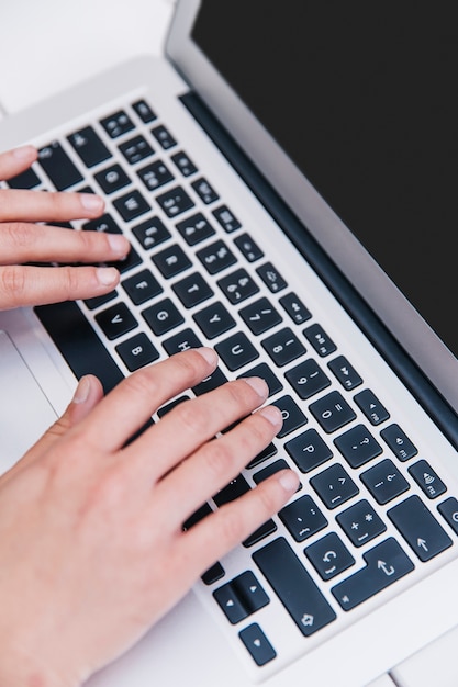 Close-up of person typing on keyboard