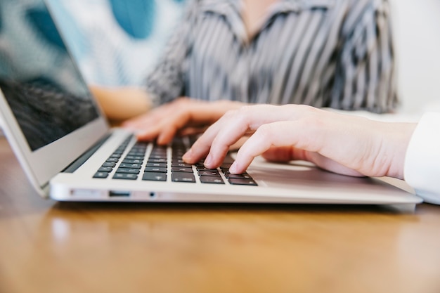 Free photo close-up of person typing on laptop