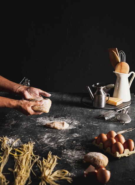 Close-up person with dough and dark background