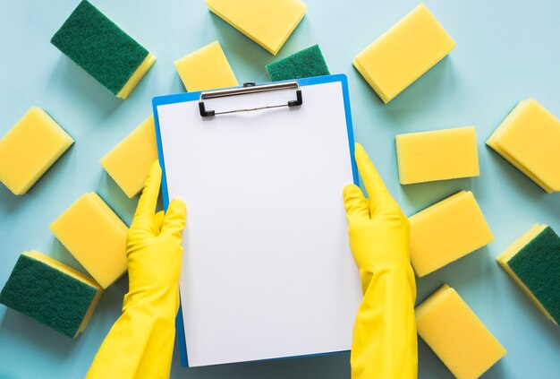 Close-up person with gloves holding clipboard