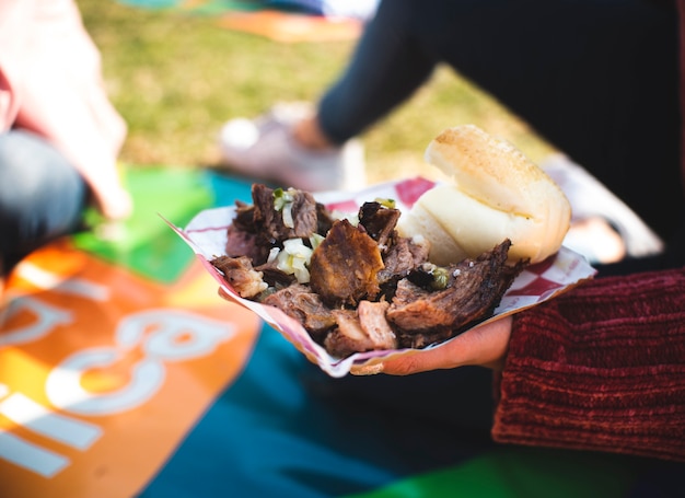 Close-up person with meat at picnic