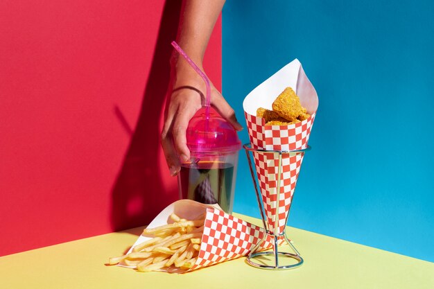 Close-up person with nuggets and juice cup