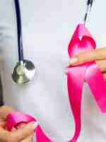 Free photo close-up person with stethoscope and pink ribbon