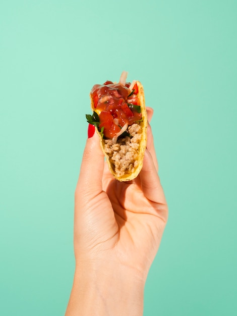 Free photo close-up person with taco and green background