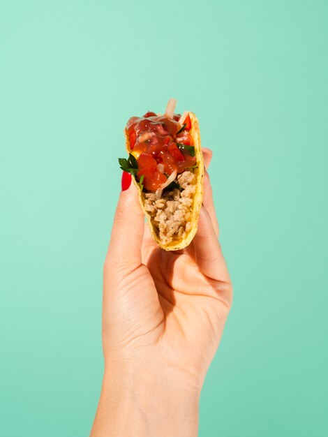 Close-up person with taco and green background