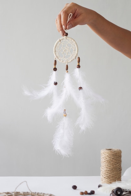 Close up on person working on dreamcatcher