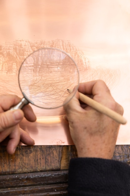 Close up on person working on engraving