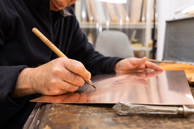 Close up on person working on engraving