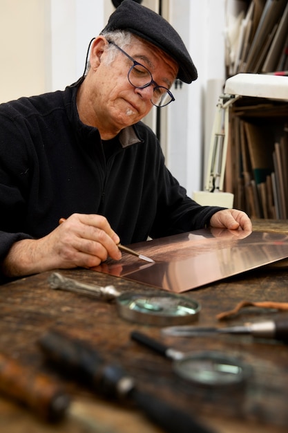 Close up on person working on engraving