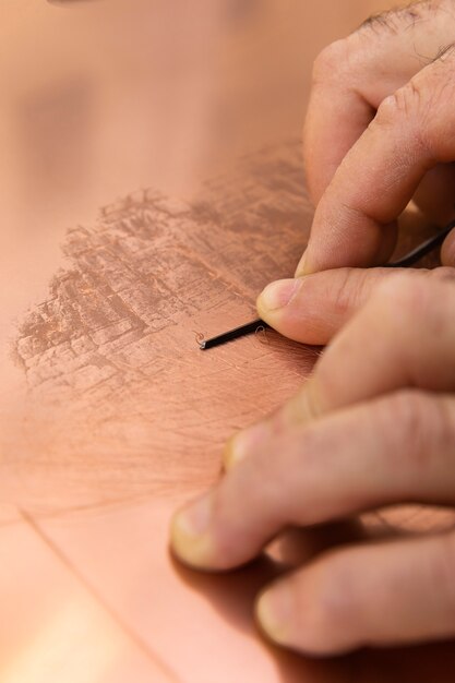 Close up on person working on engraving