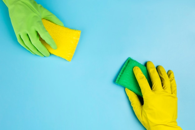 Free photo close-up persons with different gloves and sponges