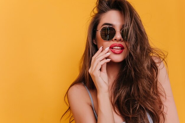 Close-up photo of beautiful white girl in black sunglasses