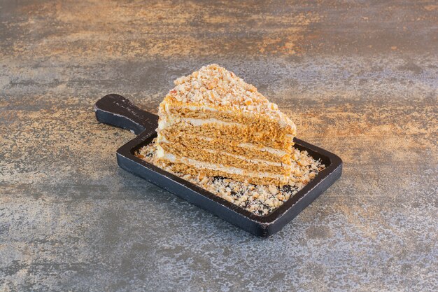 Close up photo of cake slice on wooden board on rustic