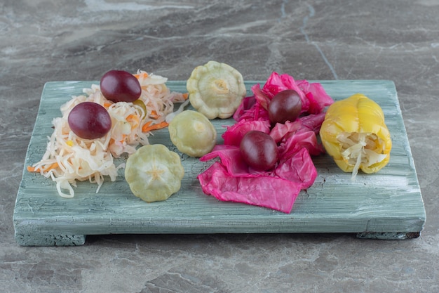 Close up photo of canned vegetables on wooden board.