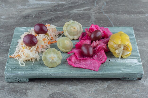 Close up photo of canned vegetables on wooden board.