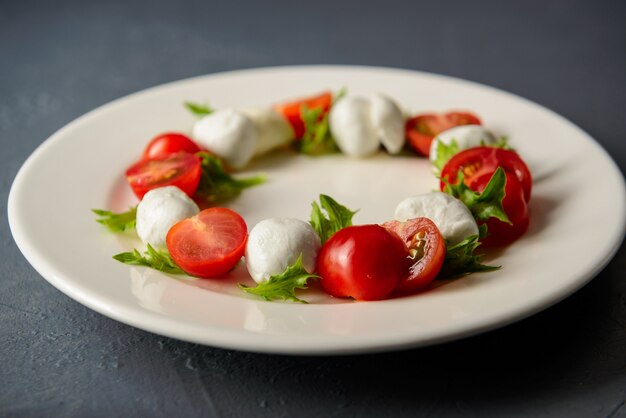 Close-up photo of caprese salad with mozzarella and tomato