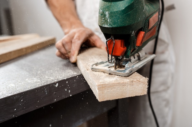 Close up photo of cutting wood with fretsaw.