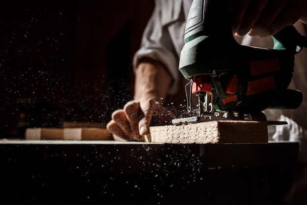 Close up photo of cutting wood with fretsaw.