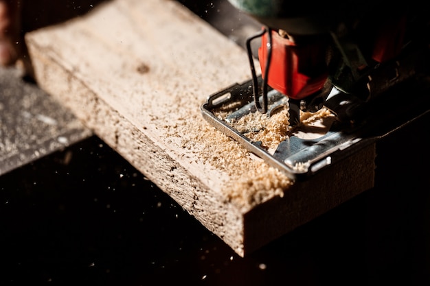 Close up photo of cutting wood with fretsaw.