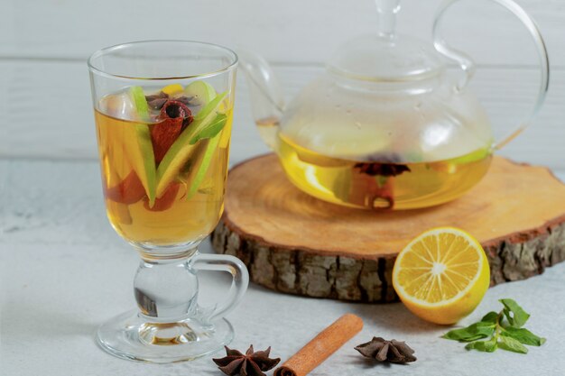 Close up photo of Fresh apple cocktail with cocktail pot on wooden board. 