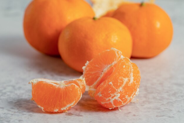 Close up photo of fresh clementine mandarin slices . 