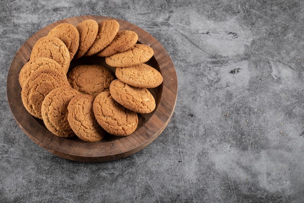 Close up photo of fresh homemade cookies. Delicious cookies on wooden tray. 