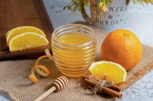 Close up photo of Fresh orange with honey .