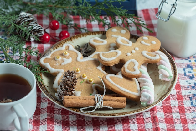 Close up photo of fresh tea and Christmas cookies.