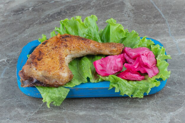 Close up photo of Grilled chicken meat and lettuce . 