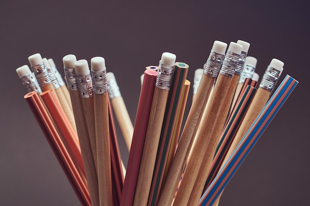 Close-up photo of a group multicolored pencils. isolated on a gray background.