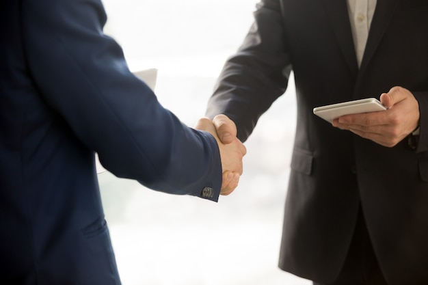 Close up photo of IT businessmen shaking hands