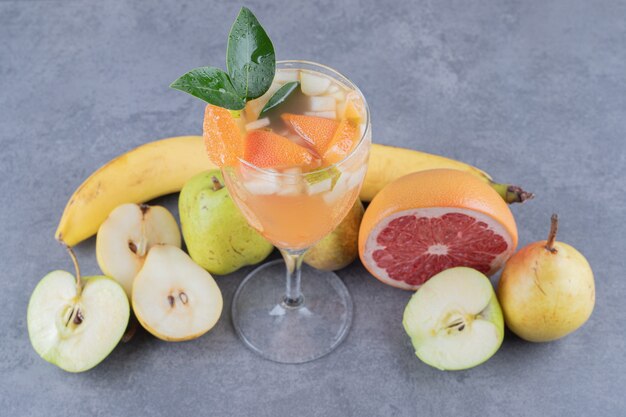 Close up photo of mixed fruit juice cocktail and season fruits.