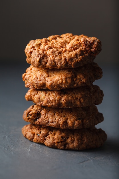 Close-up photo of oatmeal cookies stack on gray surface