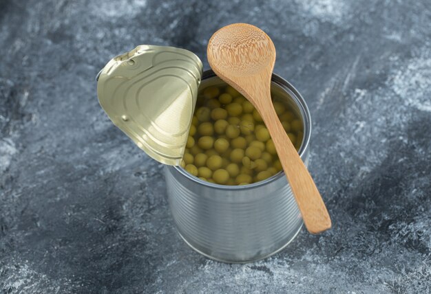 Close up photo of opened tin green peas  