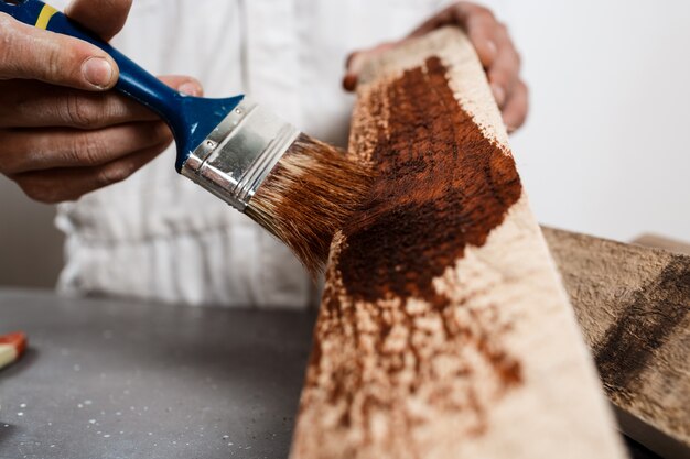 Close up photo of painting wood in brown color.