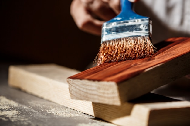 Close up photo of painting wood in brown color.